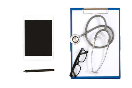 Medical equipment: gray stethoscope and tablet on white background. glasses on white paper,desktop...