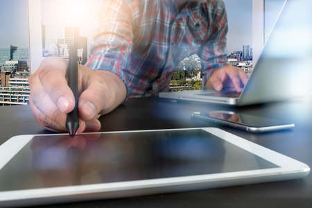 Businessman hand working with new modern computer and smart phone as business conceptの写真素材