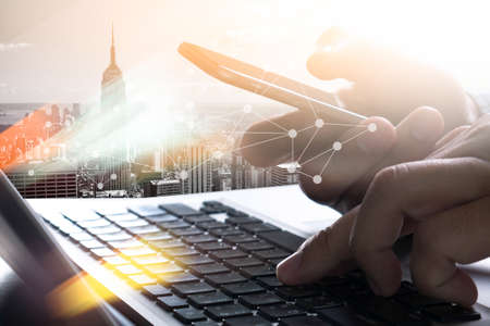 designer  work and smart phone and laptop on wooden desk in office  background media diagram