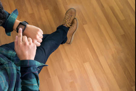 Man clicking on a screen of his smart watchの写真素材