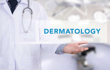 DERMATOLOGY message on Medical Doctor holding handsの写真素材