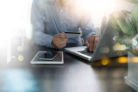 man using laptop and holding credit card with as Online shopping concept