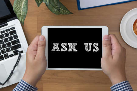 Ask us Contact  Concept man hand Tablet with blank black screen and coffee cup