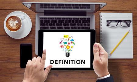 DEFINITION word, business concept, on the tablet pc screen held by businessman hands - online, top viewの写真素材