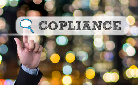 Compliance Concept, Business man with hand pressing a button on blurred abstract backgroundの写真素材
