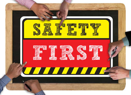 Safety First Warning concect vintage blackboard with wooden frame on white background.の写真素材