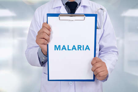 MALARIA  CONCEPT Medical Portrait of a doctor writing a prescriptionの写真素材