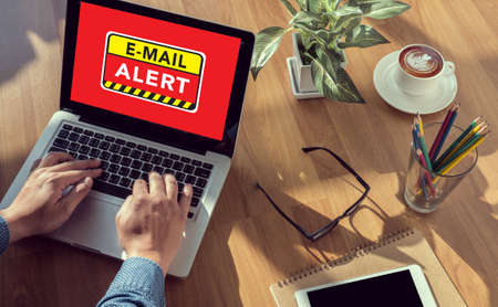 E-mails Hacked Warning Digital Browsing Concept man hand on table Business, coffee, Split toneの写真素材