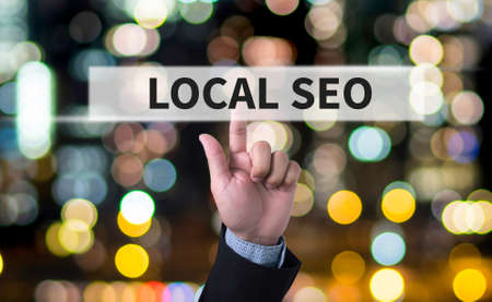 Local SEO Concep Business man with hand pressing a button on blurred abstract backgroundの写真素材