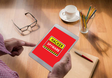 Warning Spyware Concept touch digital tablet, coffeeの写真素材