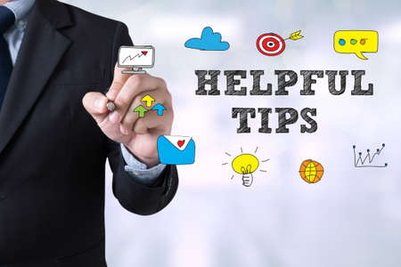 HELPFUL TIPS CONCEPT Businessman drawing Landing Page on blurred abstract backgroundの写真素材