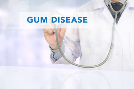 GUM DISEASE CONCEPT Medicine doctor hand working on virtual screenの写真素材