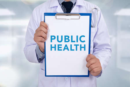 PUBLIC HEALTH CONCEPT   Portrait of a doctor writing a prescriptionの写真素材