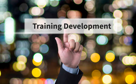 Training Development concept Business man with hand pressing a button on blurred abstract backgroundの写真素材