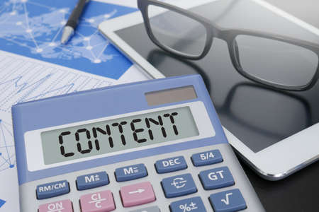 CONTENT Calculator  on table with Office Supplies.の写真素材