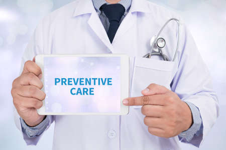 PREVENTIVE CARE  Doctor holding  digital tabletの写真素材