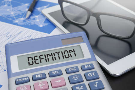 DEFINITION CONCEPT                     Calculator  on table with Office Supplies.の写真素材