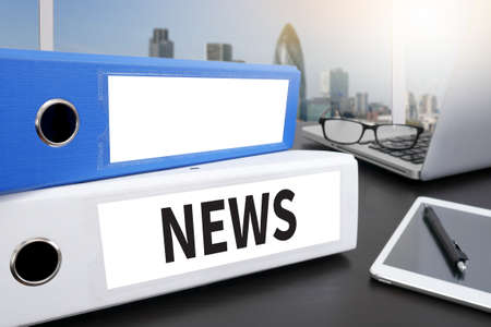 NEWS Office folder on Desktop on table with Office Supplies.の写真素材