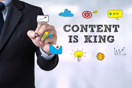 CONTENT IS KING concept Businessman drawing Landing Page on blurred abstract backgroundの写真素材