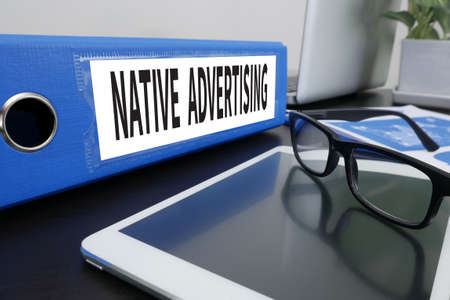 NATIVE ADVERTISING Office folder on Desktop on table with Office Supplies. ipadの写真素材