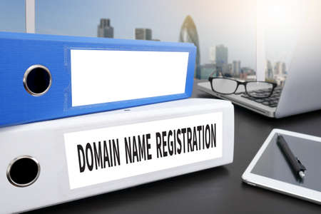 DOMAIN NAME REGISTRATION Office folder on Desktop on table with Office Supplies.の写真素材