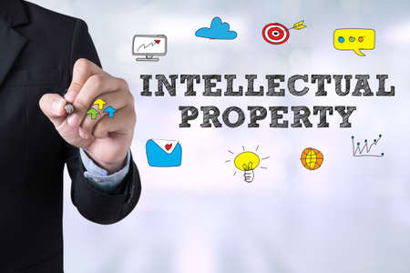 INTELLECTUAL PROPERTY Businessman drawing Landing Page on blurred abstract backgroundの写真素材