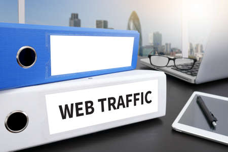 WEB TRAFFIC Office folder on Desktop on table with Office Supplies.の写真素材