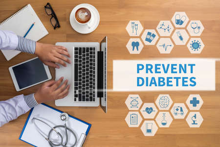PREVENT DIABETES Professional doctor use computer and medical equipment all around, desktop top view, coffeeの写真素材