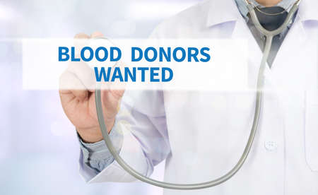 BLOOD DONORS WANTED Medicine doctor hand working on virtual screenの写真素材