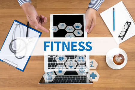 FITNESS Doctor touch digital tablet, desktop with medical equipment on background, top view, coffeeの写真素材
