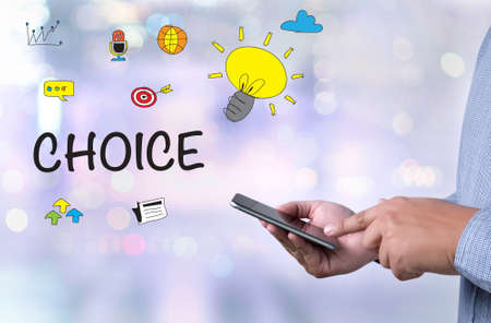 CHOICE person holding a smartphone on blurred cityscape backgroundの写真素材