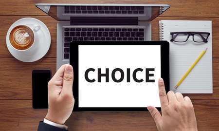 CHOICE , on the tablet pc screen held by businessman hands - online, top viewの写真素材