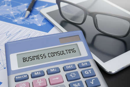 BUSINESS CONSULTING CONCEPT Calculator  on table with Office Supplies. ipadの写真素材