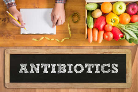 ANTIBIOTICS CONCEPT fresh vegetables and  on a wooden tableの写真素材