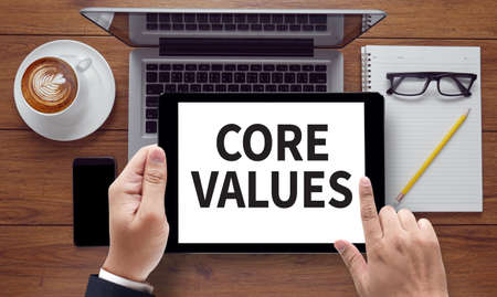CORE VALUES, on the tablet pc screen held by businessman hands - online, top viewの写真素材