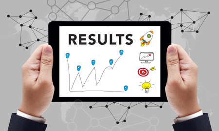 RESULTS  Concept on the tablet pc screen by businessman hands, top viewの写真素材