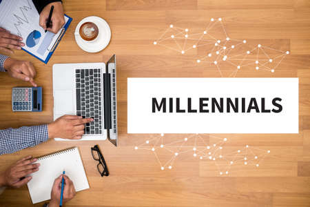 MILLENNIALS CONCEPT Business team hands at work with financial reports and a laptopの写真素材