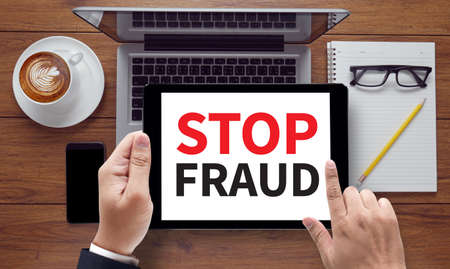STOP FRAUD, on the tablet pc screen held by businessman hands - online, top viewの写真素材