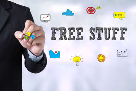 FREE STUFF Businessman drawing Landing Page on blurred abstract backgroundの写真素材