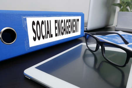 SOCIAL ENGAGEMENT Office folder on Desktop on table with Office Supplies. ipadの写真素材
