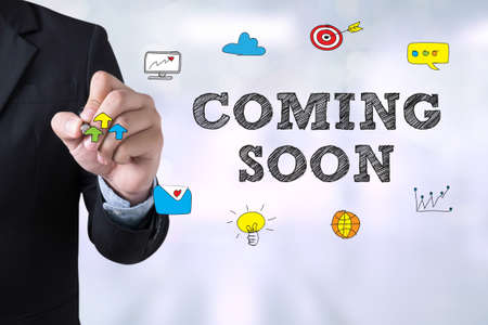 COMING SOON Businessman drawing Landing Page on blurred abstract backgroundの写真素材