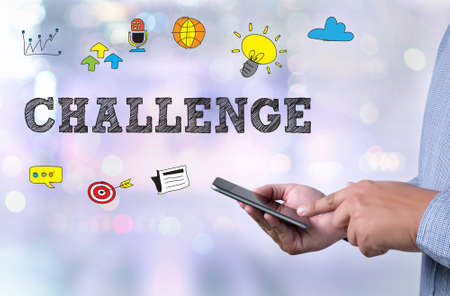 CHALLENGE person holding a smartphone on blurred cityscape backgroundの写真素材