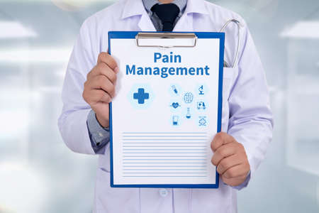 Pain Management Portrait of a doctor writing a prescriptionの写真素材