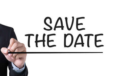 SAVE THE DATE  Businessman hand writing with black marker on white backgroundの写真素材