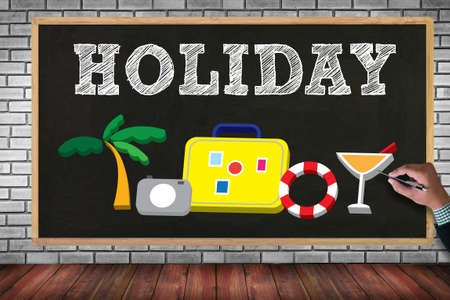 HOLIDAY HOMEPAGE on brick wall and chalkboard backgroundの写真素材