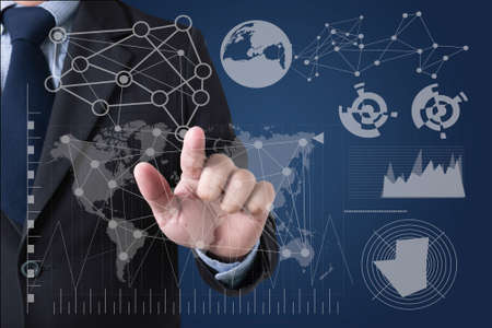 FINANCIALS Businessman hands touching on virtual screen and blurred city background