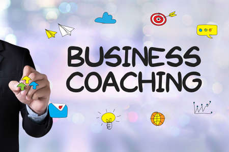 BUSINESS COACHING  (Coaching Skills Teach Teaching Training ) and Businessman drawing Landing Page on white backgroundの写真素材
