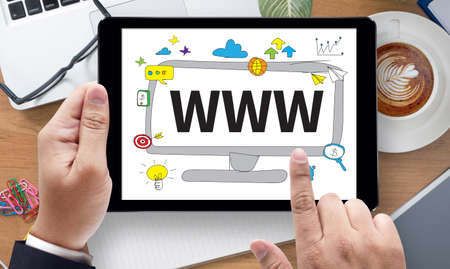 WWW Website Online Internet Web Page computer, on the tablet pc screen held by businessman hands - online, top viewの写真素材