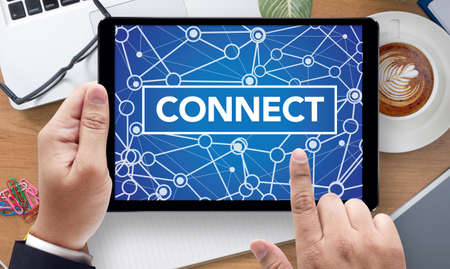 CONNECT  (Connected Communication Connection Media), on the tablet pc screen held by businessman...
