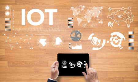 IOT hands at work with financial reports and a laptop with other objects around, coffee, top...